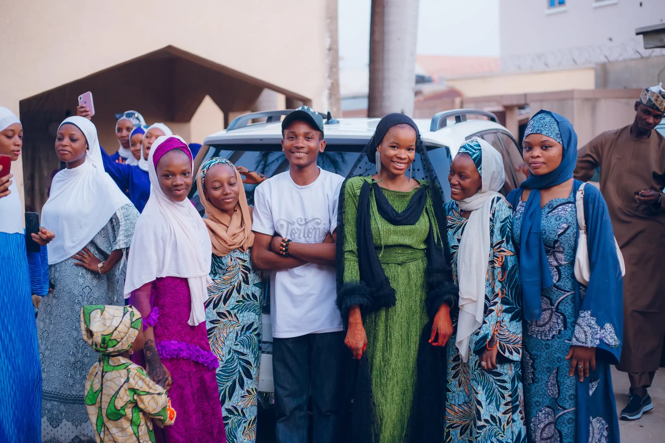 Illustrative stock photograph of African friends and neighbours standing together outdoors; they are not shown taking part in a CVID-CAM activity