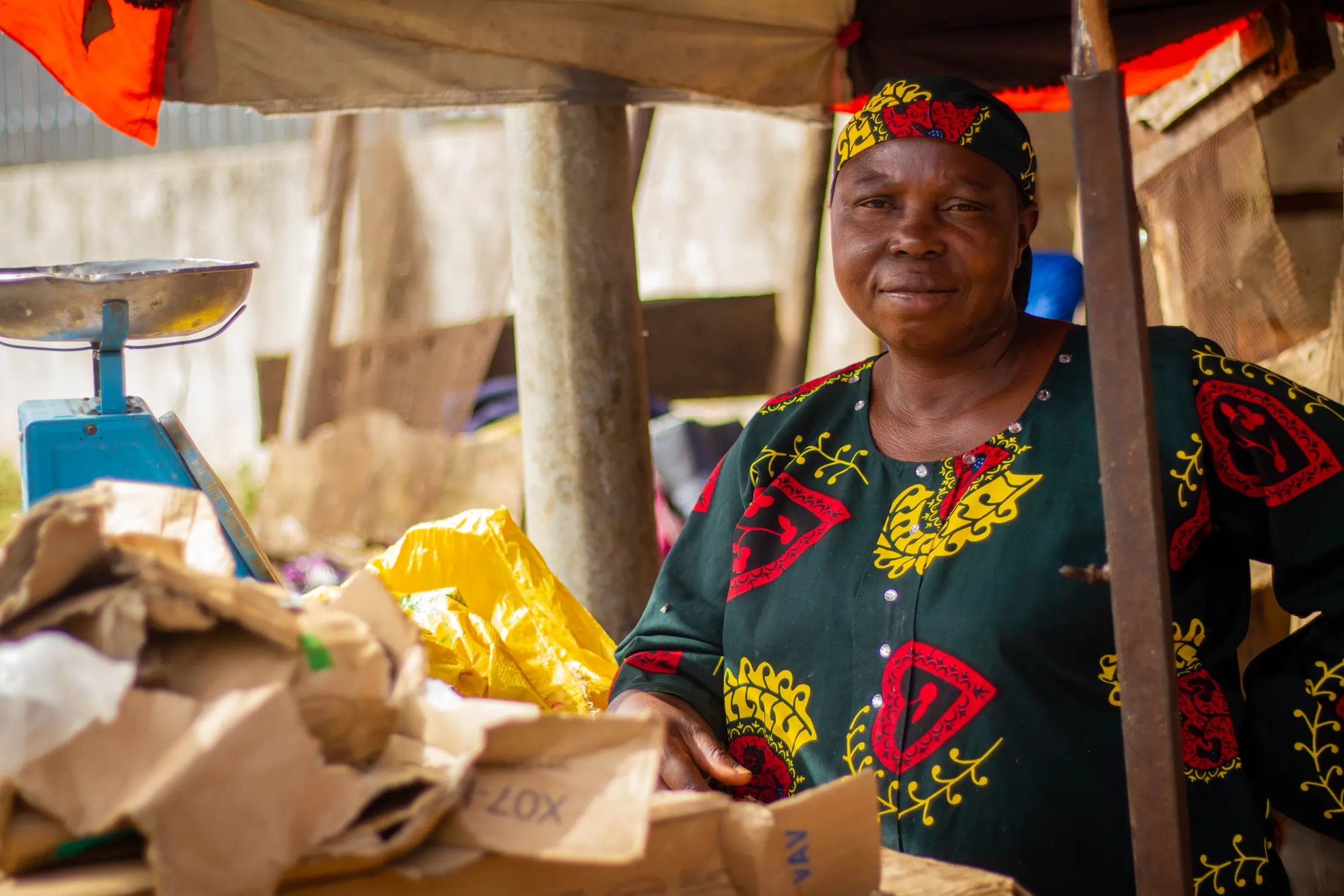 Illustrative stock photograph of an African woman working at a market stall; she is not shown taking part in a CVID-CAM program